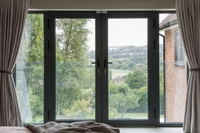 internal-view-of-a-modern-Juliet-balcony-with-Schuco-aluminium-casement-doors-and-fixed-sidelights